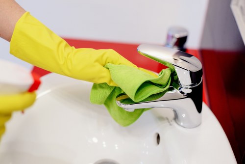 Technician cleaning carpet with safety equipment in a Tufnellpark property
